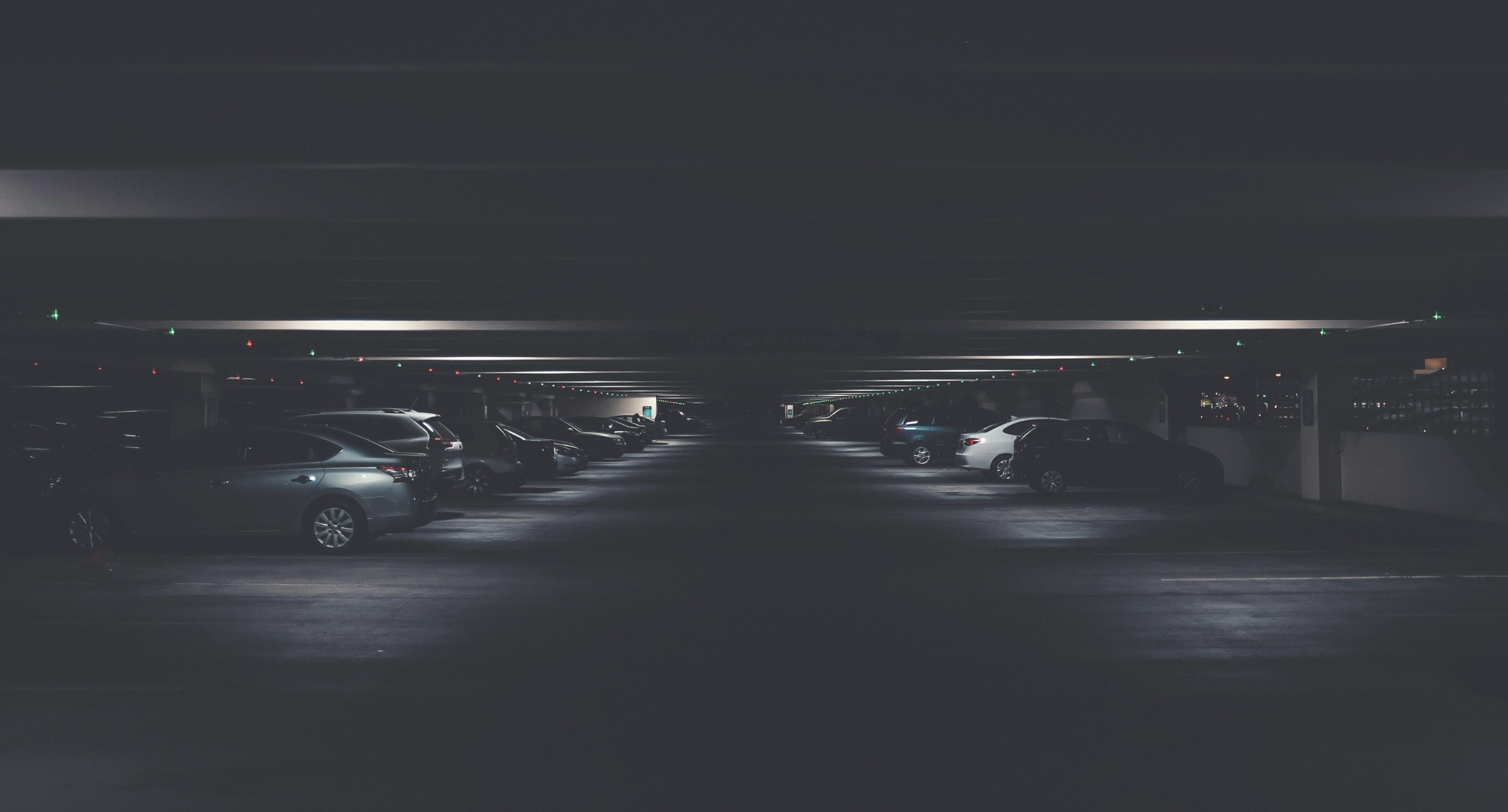 Vehicles lined up in a dramatically lit automotive setting